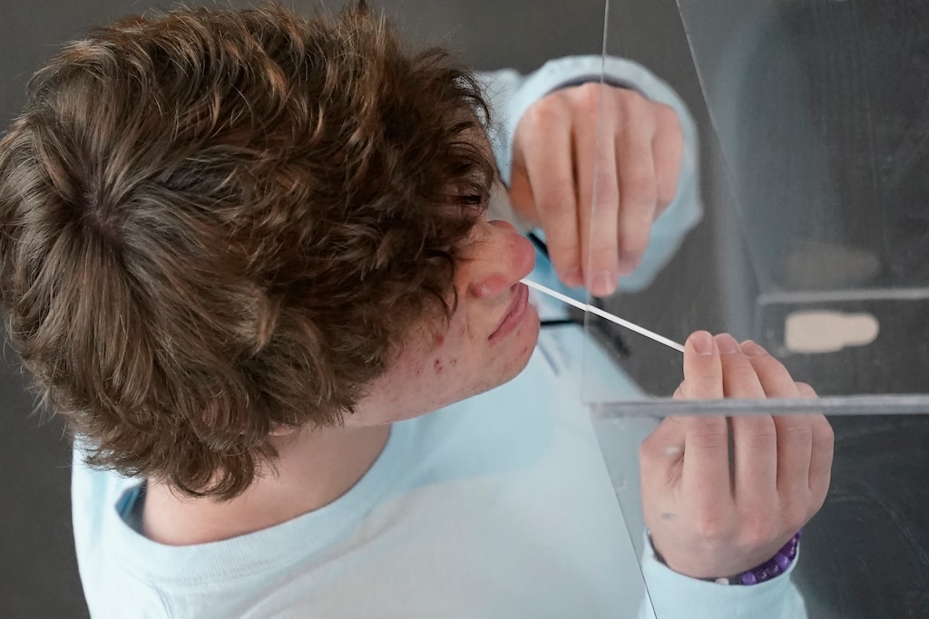 (Rick Bowmer | AP) University of Utah student James Calder takes a rapid COVID-19 test Wednesday, Nov. 18, 2020, in Salt Lake City. As college students prepare to go home for the holidays, some schools are quickly ramping up COVID-19 testing to try to keep infections from spreading further as the coronavirus surges across the U.S.