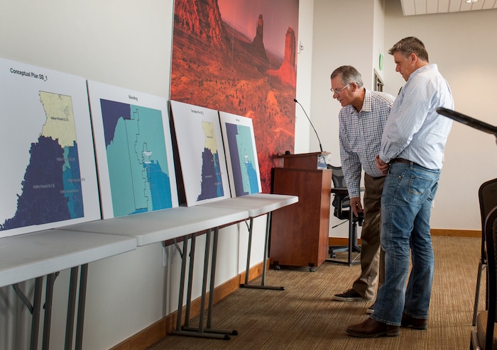 (Leah Hogsten  |  The Salt Lake Tribune) l-r San Juan County Commissioners Bruce Adams and Phil Lyman get a better look at the county population divisions in the proposed redistricting map for school districts prior to the meeting in Monticello on Thursday. San Juan County residents were presented with proposals of the newly redrawn county commission and school board districts during hearings in Monticello and Bluff, November 16, 2017. The redistricting proposals would redraw voting districts to ensure significant American Indian majorities in two of three County Commission districts and on four of five school board voting districts as the result of a January 2012 lawsuit filed in U.S. District Court by the Navajo Nation. The lawsuit seeks the redrawing of voting districts to reflect the 2010 U.S. Census. Last year, U. S. District Court Judge Robert Shelby ruled the voting districts in the sprawling southeastern Utah county, which today is home to 16,895 residents, are unconstitutional and violate the rights of American Indians. He ordered the county to redraw them.
