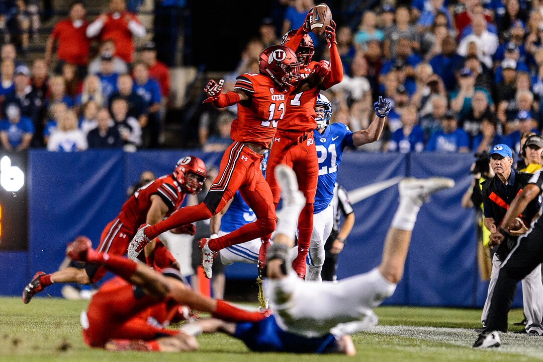 (Trent Nelson | The Salt Lake Tribune)  Utah Utes defensive back Jaylon Johnson (7) pulls in an interception as Brigham Young Cougars quarterback Tanner Mangum (12) is brought down by Utah Utes defensive end Caleb Repp (47), but is ruled out of bounds as BYU hosts Utah, NCAA football in Provo, Saturday September 9, 2017.