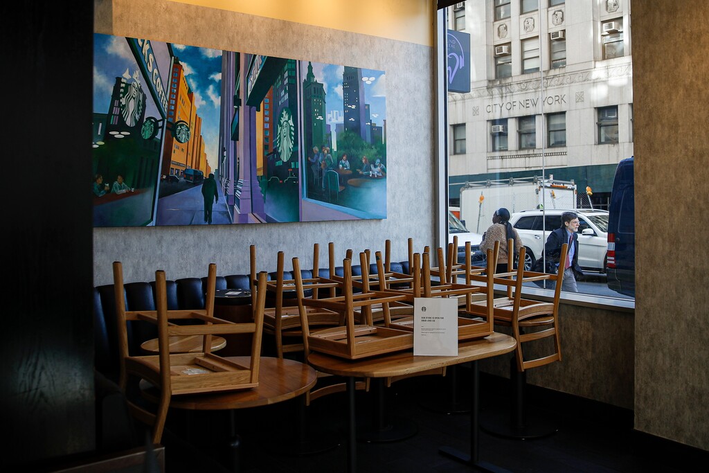 (AP Photo/John Minchillo)

Chairs are stacked in a Starbucks coffee shop that remained open for customers purchasing for take-away, Monday, March 16, 2020, in New York.