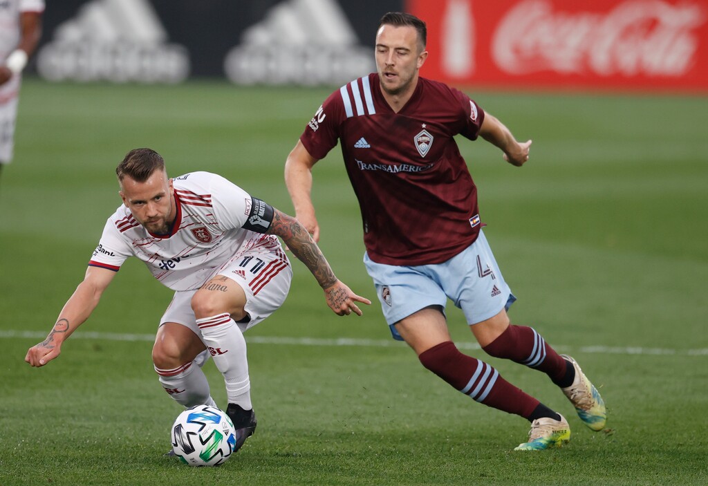 Real Salt Lake midfielder Albert Rusnak, left, fights for control of the ball with Colorado Rapids defender Danny Wilson during the first half of an MLS soccer match Saturday, Aug. 22, 2020, in Commerce City, Colo. (AP Photo/David Zalubowski)