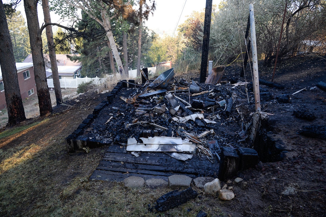(Francisco Kjolseth  |  The Salt Lake Tribune)  A shed smolders  belonging to Alysa Albertine who recalled the harrowing experience of having to flee her home in East Bountiful when a wildfire ignited in the early hours on Friday morning, Aug. 30, 2019. The fire was so close her shed was destroyed and three of her neighbors experienced a total loss of their homes. On Sept. 2, officials said the fire was 100% contained.