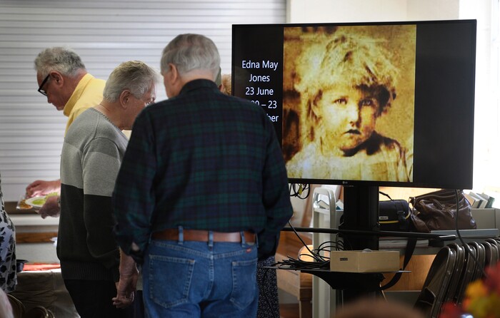 (Scott Sommerdorf | The Salt Lake Tribune)
Family members line up to take lunch as family photos play on a slideshow playing during their reunion at the Bountiful Tabernacle, Thursday, November 9, 2017.