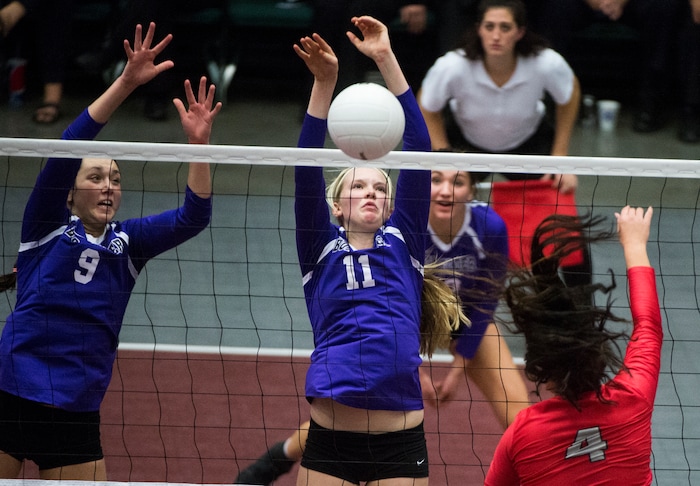 (Rick Egan  |  The Salt Lake Tribune) Bountiful Braves Brook Pe’a (4) hits the ball, as Box Elder Bees Jaida Burt (9) Emily Isaacson (11) defend, in 5A volleyball championship game, Bountiful vs. Box Elder, at Utah Valley University, Saturday, November 4, 2017.