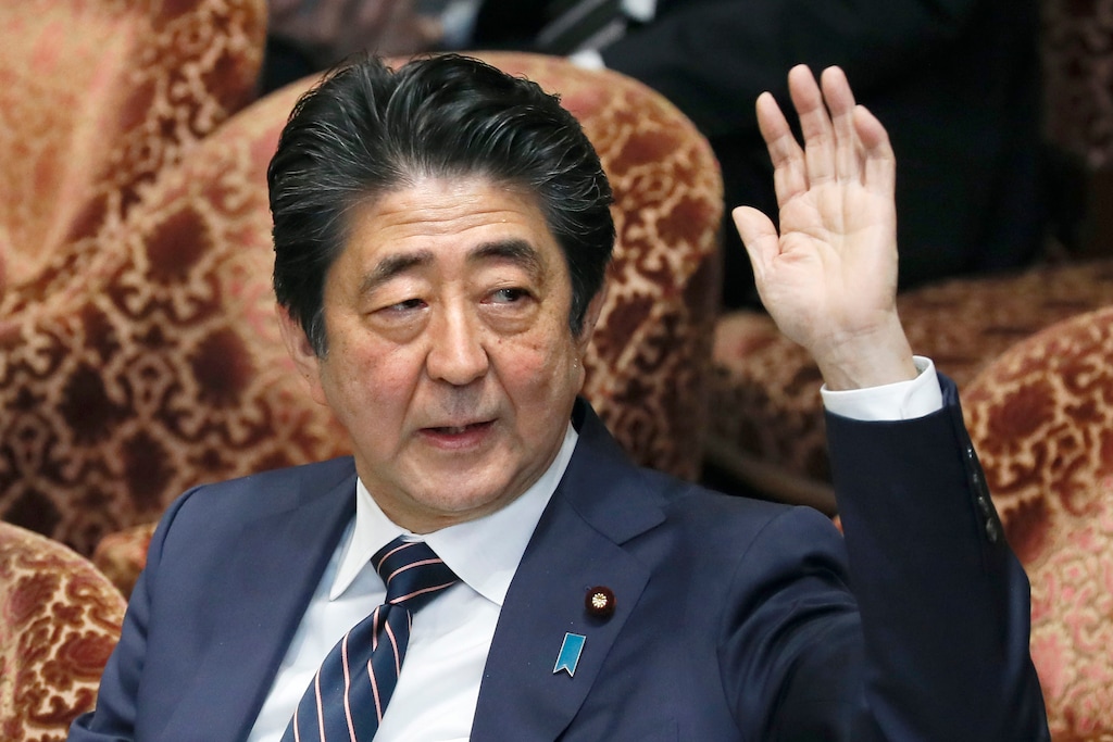 (Kyodo News via The Associated Press) Japanese Prime Minister Shinzo Abe raises his hand during a parliamentary session at the Lower House in Tokyo, Monday, Feb. 18, 2019. Abe and his chief spokesman have declined to say if Abe nominated President Donald Trump for a Nobel Peace prize.