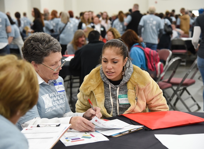 (Francisco Kjolseth  |  The Salt Lake Tribune)  Crystal Yllnas is helped by volunteer LeAnne Heagren as she decides on what services to access during Salt Lake CityÕs second annual Project Homeless Connect at the Salt Palace Convention Center on Friday, Oct. 12, 2018. The event brought together community volunteers to provide services for individuals and families in need or experiencing homelessness. More than 800 community volunteers and 90 service providers connect those in need with more than 200 services.
