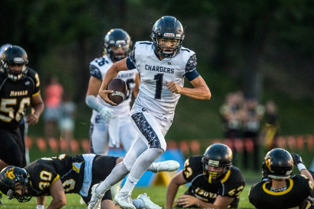 Chris Detrick  |  The Salt Lake Tribune
Corner Canyon's Zach Wilson (1) runs past Roy defenders during the game at Roy High School Friday September 2, 2016. Corner Canyon defeated Roy 36-6.