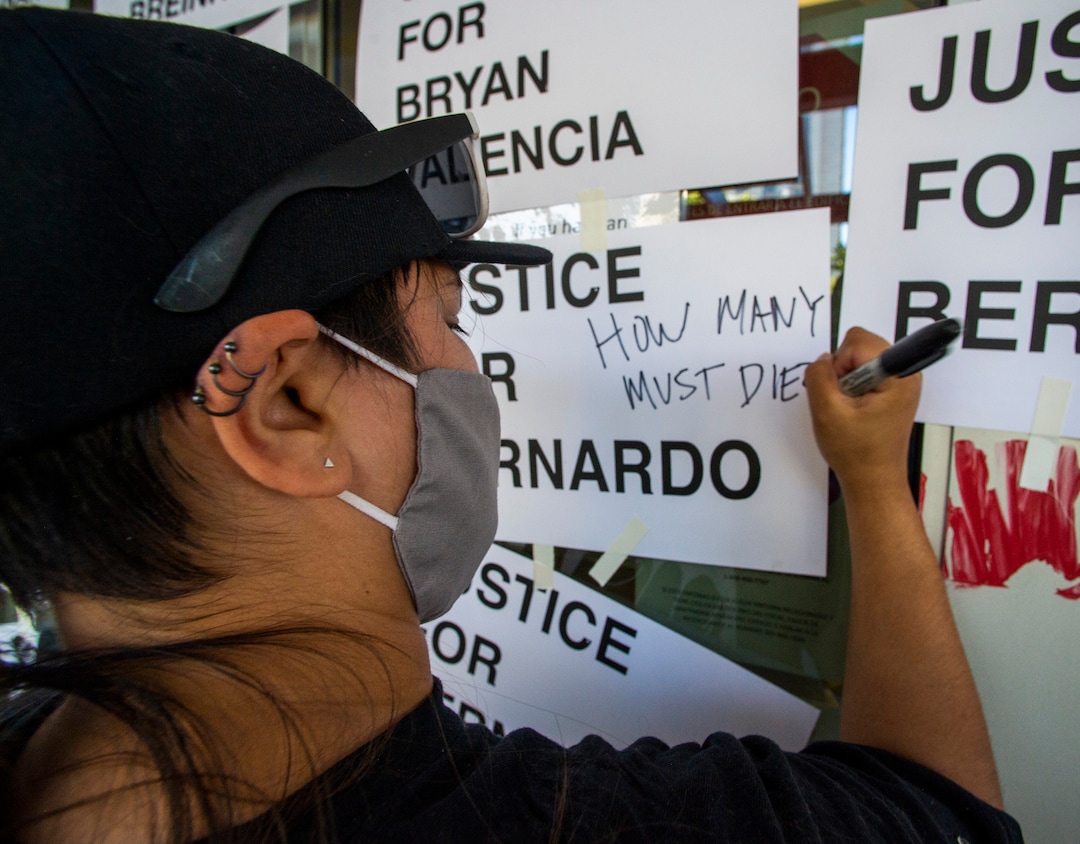 (Rick Egan  |  The Salt Lake Tribune)     Protesters put new signs on the Salt Lake District Attorney's Office, during a protest to draw attention to Chad Breinholt and Bryan Valencia, who, like Bernardo Palacios were killed by the police, Wednesday, July 8, 2020.