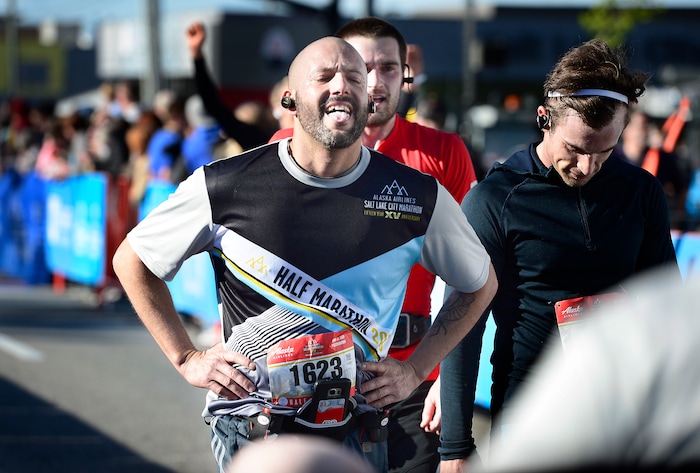 (Scott Sommerdorf | The Salt Lake Tribune)An exhausted runner crosses the finish line in the Salt Lake City half marathon, Saturday, April 21, 2018.