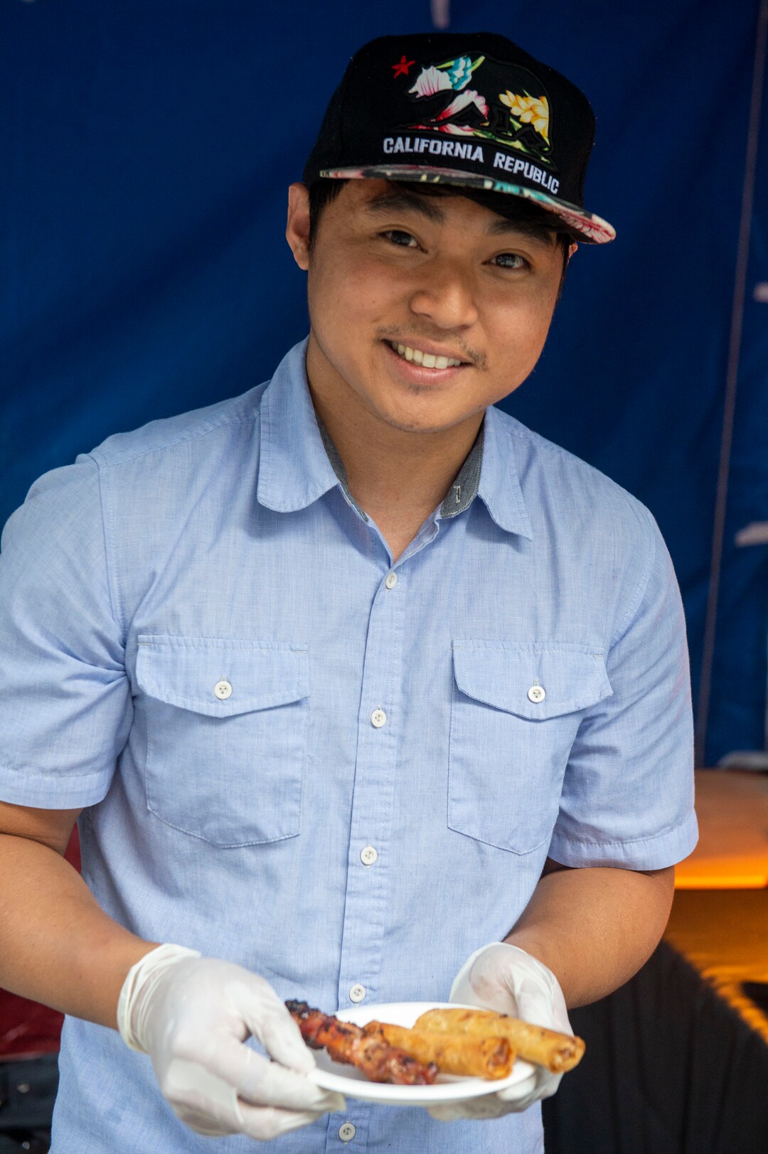 (Rick Egan  |  The Salt Lake Tribune)     Johndel serves serves Love from the Ialnds at his Kuya Del booth at the Gallivan Center, as Salt Lake City's Spice Kitchen Incubator program serves a variety of international cuisine at the welcome party for the United Nations Civil Society Conference, Sunday, Aug. 25, 2019.