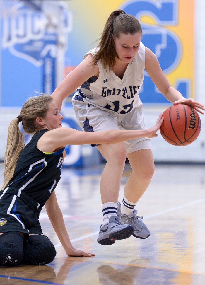 (Leah Hogsten  |  The Salt Lake Tribune) Pleasant Grove's Kenna Sparks knocks the ball from Copper Hills' Kayla Barker.   Copper Hills High School girls' basketball team defeated Pleasant Grove High School 66-25 during their Class 6A girls' basketball playoff opener at Salt Lake Community College Tuesday, Feb. 20, 2018. 