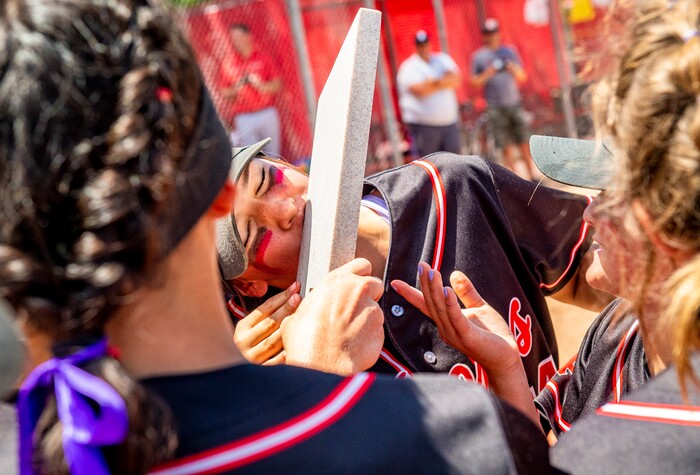 (Isaac Hale | Special to The Tribune) Spanish Fork pitcher Peyton Hall (14) kisses the championship trophy after the Spanish Fork Lady Dons defeated the Mountain Ridge Sentinels in a best-of-three series to win the 5A state softball championship at the Spanish Fork Sports Park on Friday, May 28, 2021.