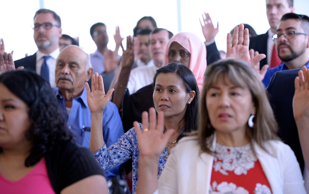 (Al Hartmann  |  The Salt Lake Tribune) 	47 soon-to-be American citizens from 22 countries raise their right hand and take the oath of alligiance at a citizenship and naturalization ceremony at the Federal Court building in Salt Lake City Wednesday May 9.  The U.S. Citizenship and Immigration Services (USCIS) and the U.S. DistrictCourt welcomed 150 people from 43 countries as new U.S. citizens in three ceremonies today. 