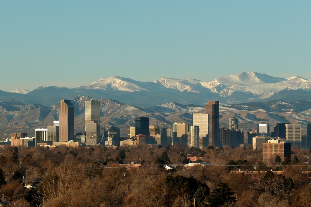 The Rocky Mountains rise beyond Denver skyline Sunday, Jan. 24, 2016. (AP Photo/Charlie Riedel)