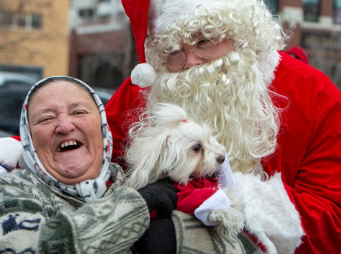 Dotty Antonio and her dog Carmela visit Santa Claus during the Street Dawg Crew Christmas outreach at Liberty Park Sunday.  The Street Dawg Crew supports the homeless and their pets every Sunday at Pioneer Park. Today besides passing out food and gift bags for humans and animals, they offered a photo opportunity with Santa. Sunday, Dec. 22, 2019.