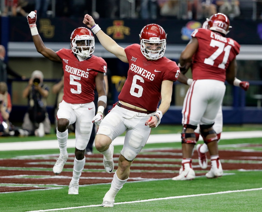 Oklahoma quarterback Baker Mayfield (6) and wide receiver Marquise Brown (5) celebrate hooking up for a long pass and touchdown score in the second half of the Big 12 Conference championship NCAA college football game against TCU on Saturday, Dec. 2, 2017, in Arlington, Texas. (AP Photo/Tony Gutierrez)