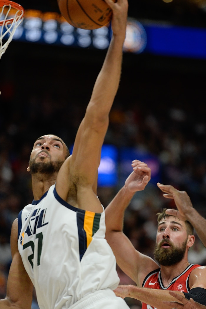 (Francisco Kjolseth  |  The Salt Lake Tribune)  Utah Jazz center Rudy Gobert (27) tries to dunk over the Raptors in the first half of the preseason NBA game at Vivint Smart Home Arena Tuesday, Oct. 2, 2018, in Salt Lake City.