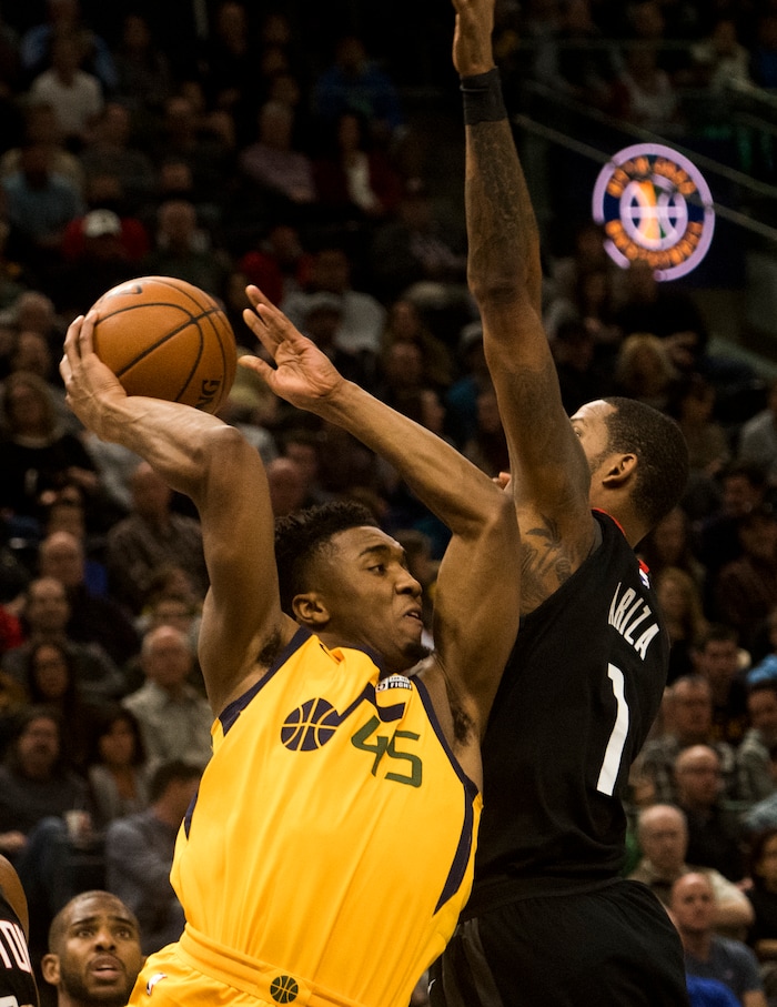 (Rick Egan  |  The Salt Lake Tribune)  Utah Jazz guard Donovan Mitchell (45) tries to pass the ball, as Houston Rockets forward Trevor Ariza (1) defends,  in NBA action, Utah Jazz vs Houston Rockets in Salt Lake City, Thursday, December 7, 2017.


