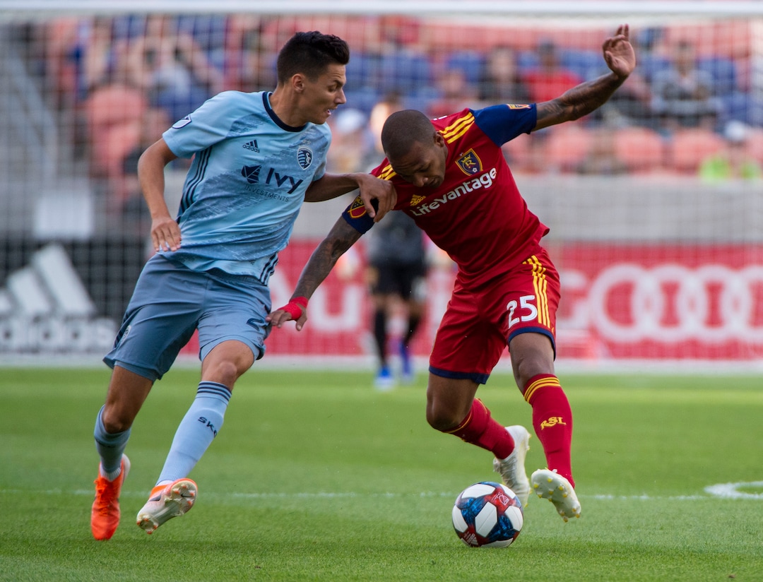 (Rick Egan  |  The Salt Lake Tribune)  Real Salt Lake midfielder Sebastian Saucedo (23) collides with Sporting Kansas City forward Daniel Salloi (20), in MLS soccer action between Real Salt Lake and Sporting Kansas City, in Sandy, Saturday, June 29, 2019.