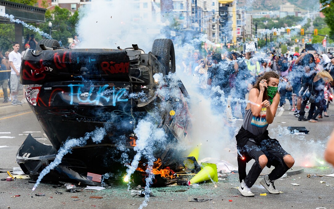 (Francisco Kjolseth  |  The Salt Lake Tribune) Marchers overturned a police car and set it on fire on Saturday, May 30, 2020.