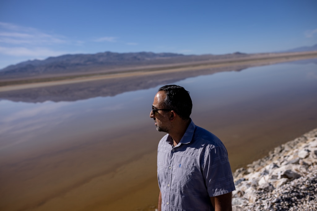 (Spenser Heaps | Deseret News) Arrash Agahi, who oversees regulatory compliance of Owens Lake for the Los Angeles Department of Water and Power, looks at an area of the lakebed that has been converted to a brine pool to reduce blowing dust while giving journalists a tour of the project area on Thursday, Aug. 11, 2022.
