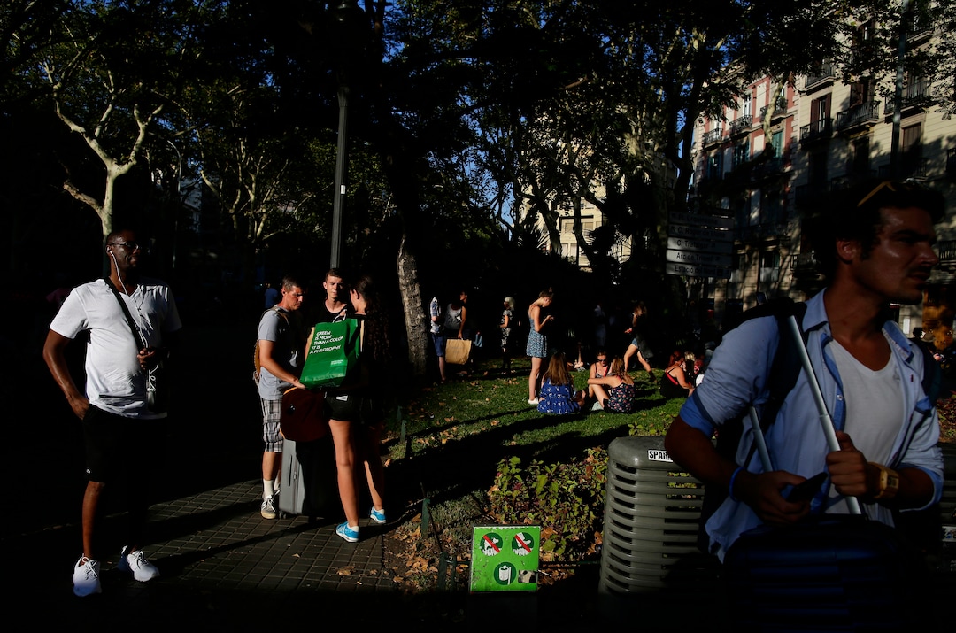 (Manu Fernandez | The Associated Press) People stand on a street in Barcelona, Spain, Thursday, Aug. 17, 2017. A white van jumped up onto a sidewalk and sped down a pedestrian zone Thursday in Barcelona's historic Las Ramblas district, swerving from side to side as it plowed into tourists and residents. Police said 13 people were killed and more than 50 wounded in what they called a terror attack.
