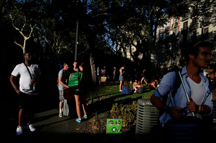 (Manu Fernandez | The Associated Press) People stand on a street in Barcelona, Spain, Thursday, Aug. 17, 2017. A white van jumped up onto a sidewalk and sped down a pedestrian zone Thursday in Barcelona's historic Las Ramblas district, swerving from side to side as it plowed into tourists and residents. Police said 13 people were killed and more than 50 wounded in what they called a terror attack.