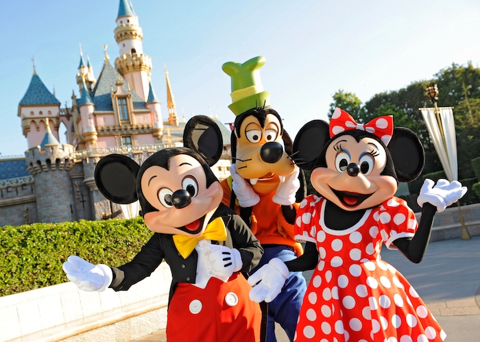 (Photo courtesy Disneyland Resort) Mickey Mouse, Goofy and Minnie Mouse welcome visitors in front of the Sleeping Beauty Castle at Disneyland.