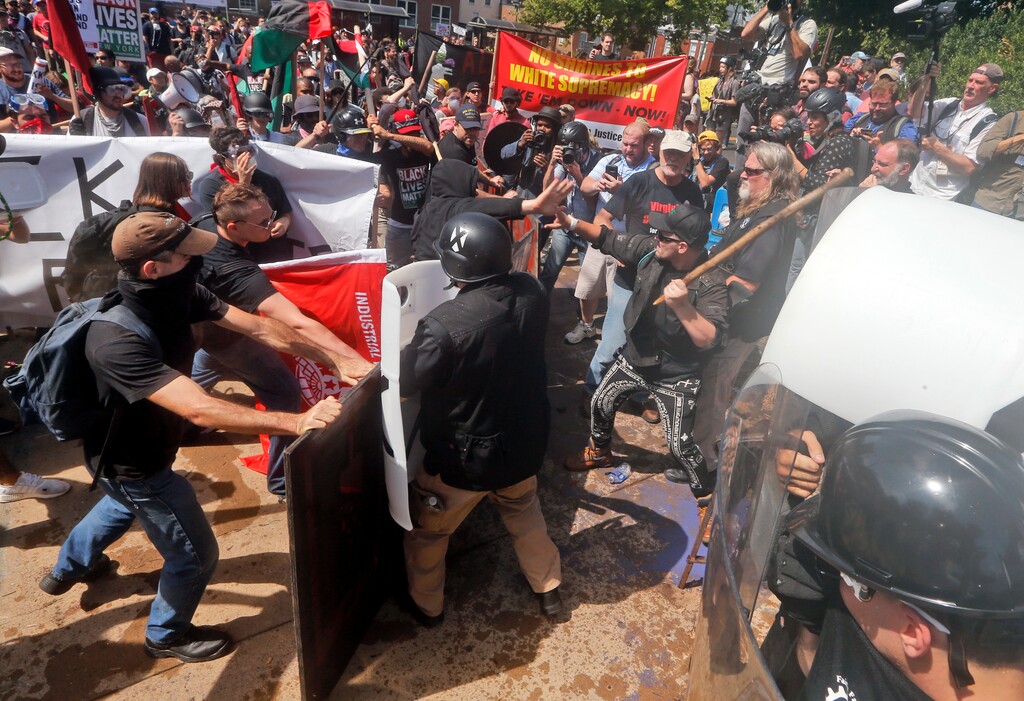 (AP Photo | Steve Helber) White nationalist demonstrators clash with counter demonstrators at the entrance to Lee Park in Charlottesville, Va., Saturday, Aug. 12, 2017. Gov. Terry McAuliffe declared a state of emergency and police dressed in riot gear ordered people to disperse after chaotic violent clashes between white nationalists and counter protestors.