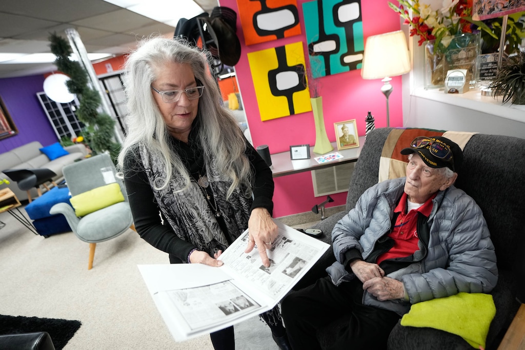 (Francisco Kjolseth | The Salt Lake Tribune) Kim Kanell Nielsen overlooks old store ads alongside her father, Plato Kanell, 95, on Thursday, Dec. 29, 2022, as the family business Kanell’s Furniture Source, which has specialized in mid-century modern furniture in Salt Lake City, nears closing.