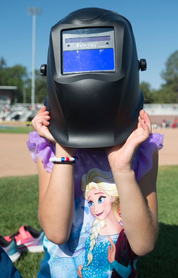  (Rick Egan  |  The Salt Lake Tribune)  Empry Rogers, 6, of Syracuse, Ut,  watch the early stages of the solar eclipse with a welding helmet, at Melaleuca Baseball Park, in Idaho Falls, Monday, August 21, 2017.



