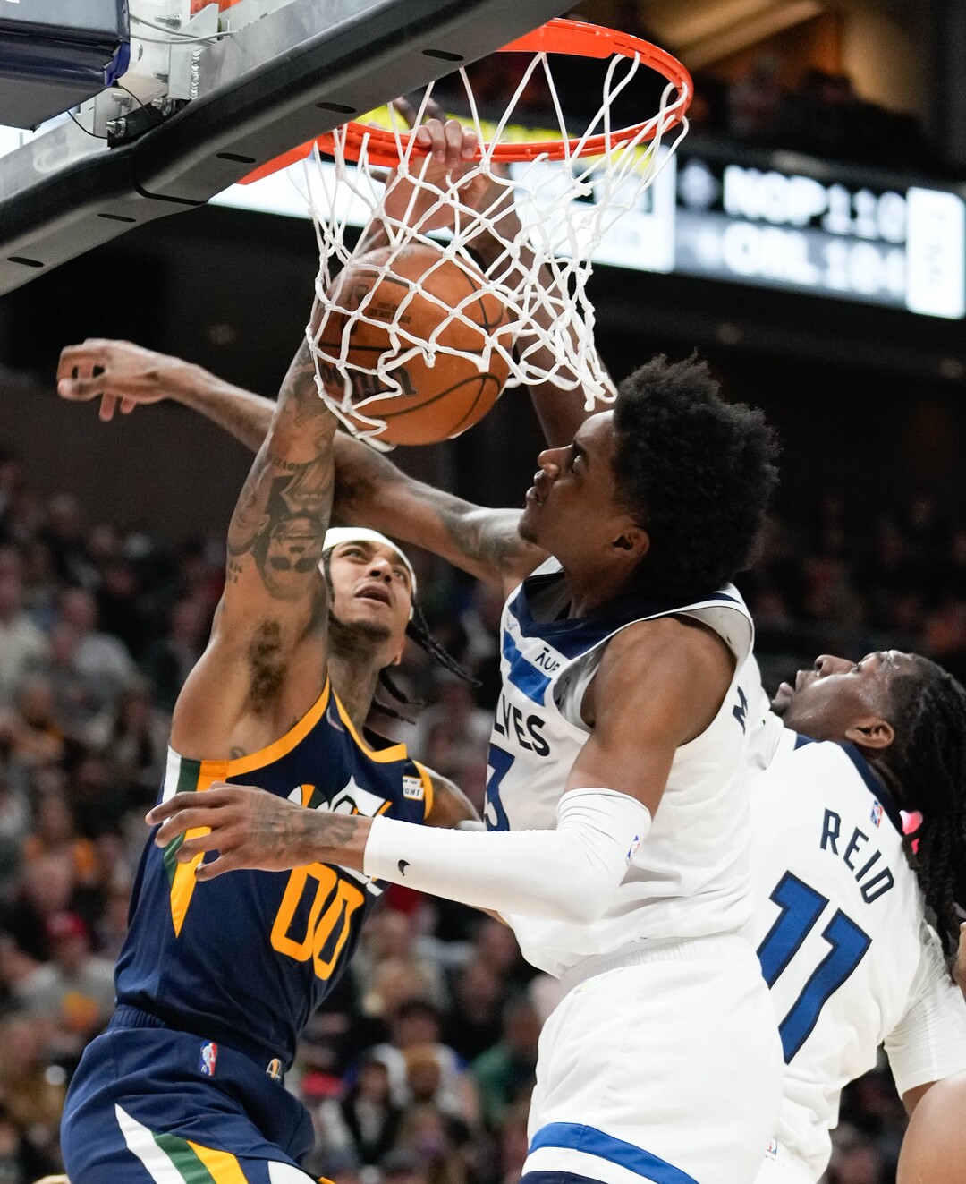 (Francisco Kjolseth | The Salt Lake Tribune) Utah Jazz guard Jordan Clarkson (00) lands a massive dunk while pressured by Minnesota Timberwolves forward Jaden McDaniels (3) and Minnesota Timberwolves center Naz Reid (11) in NBA action between the Utah Jazz and the Minnesota Timberwolves at Vivint Smart Home Arena in Salt Lake City, Thursday, Dec. 23, 2021.