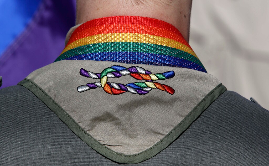 (Rick Bowmer | The Associated Press) In this June 8, 2014, file photo, a Boy Scout wears his kerchief embroidered with a rainbow knot during Salt Lake City's annual gay pride parade. An announcement Tuesday night, May 8, 2018, by The Church of Jesus Christ of Latter-day Saints and Boy Scouts will mark an end to close relationship that lasted more than a century built on their shared values. The religion will move its remaining boys into its own scouting-type program.