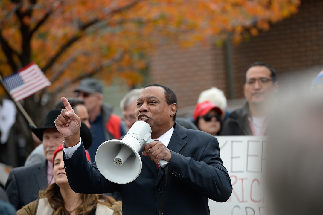 (Francisco Kjolseth | The Salt Lake Tribune) James Evans, former chair of the Utah Republican Party, uses a megaphone to excite chanting as two competing rallies spar near Rep. Ben McAdams' office in West Jordan, one seeking to support McAdams and one to criticize him for supporting the impeachment inquiry of President Donald Trump on Wednesday, Oct. 9, 2019.