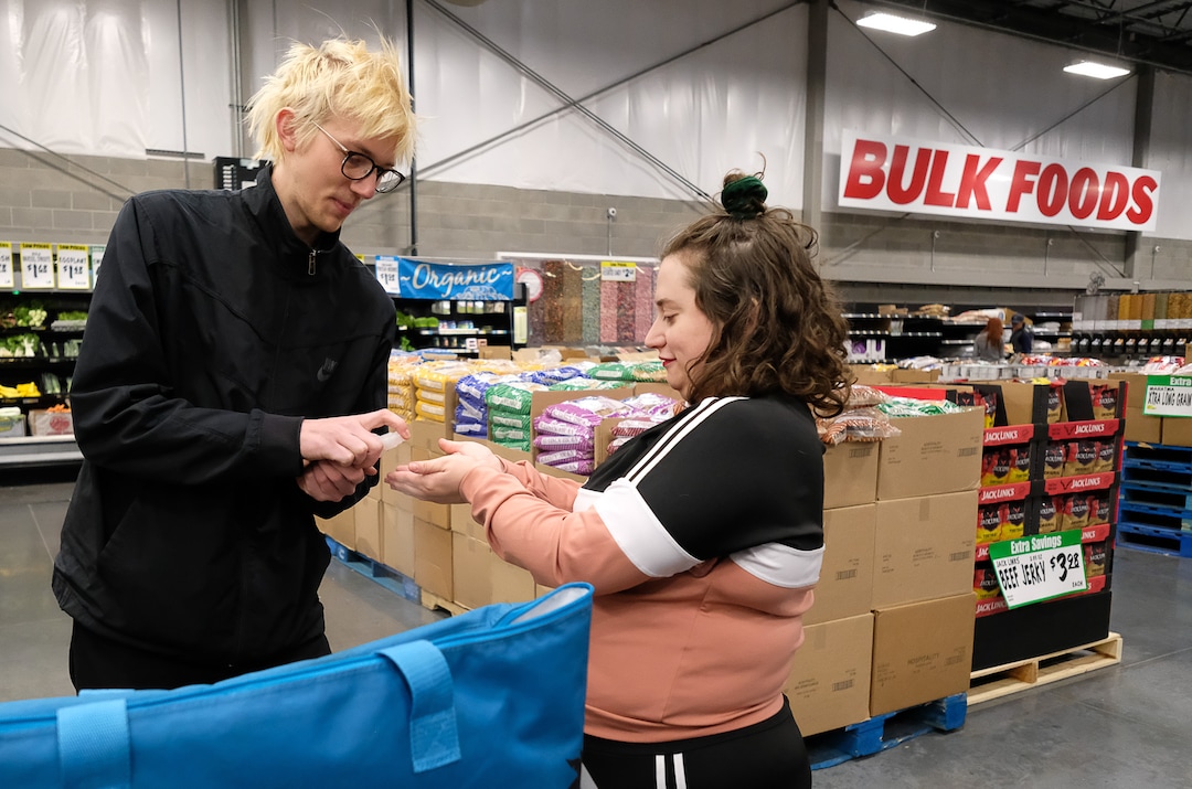 (Francisco Kjolseth  |  The Salt Lake Tribune) Shandra Benito and Taylor Almond sanitize regularly as they shop for a family at WinCo Foods in Salt Lake City on Wednesday, March 18, 2020, as part of a newly formed Salt Lake Valley COVID Mutual Aid group that connects volunteers with people who need help during the coronavirus outbreak.