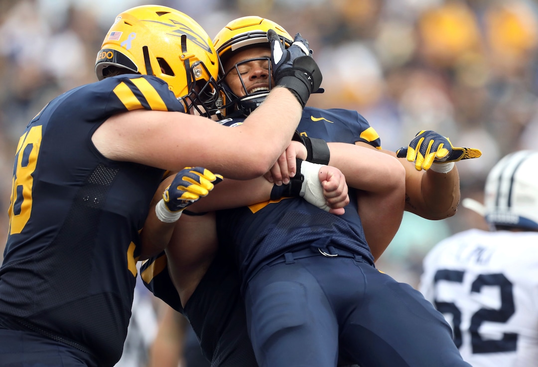 Toledo's Bryant Koback (22), being lifted, celebrates with teammates after his touchdown during a college football game between the University of Toledo and Brigham Young University at the Glass Bowl in Toledo, Ohio, on Saturday, Sept. 28, 2019. (Kurt Steiss/The Blade via AP)