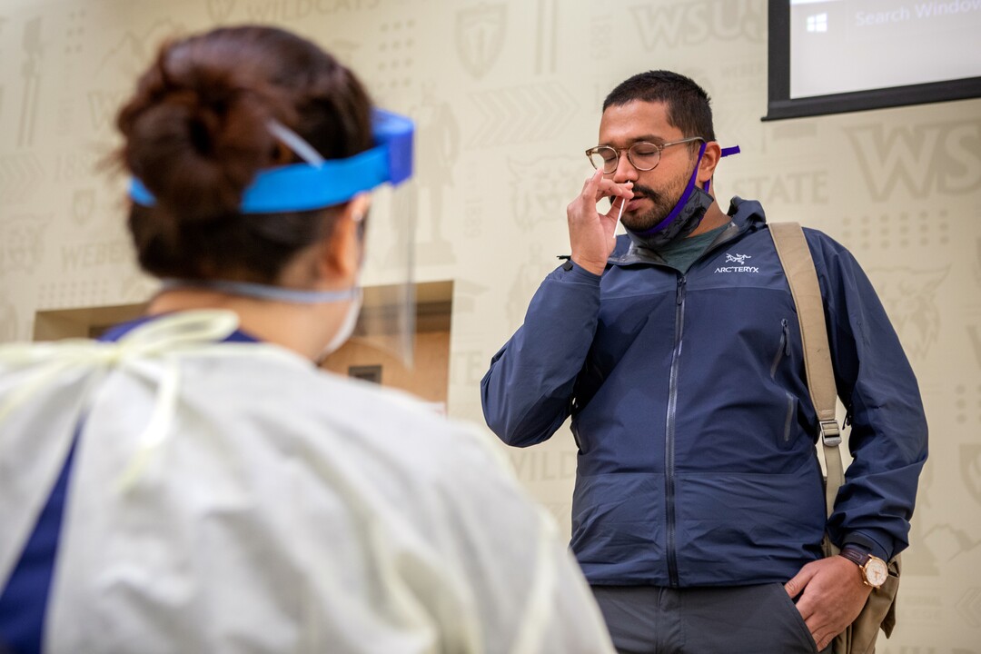 (Photo courtesy of Weber State University) Joel Skavia self-administers a COVID-19 test as Weber State University begins the first day of wide-scale COVID-19 testing for students and employees at the Ogden campus on Tuesday, November 10, 2020. Weber State had previously offered free testing for anyone with possible coronavirus symptoms. The new process will allow for free rapid testing for thousands of people even if they aren't showing symptoms.