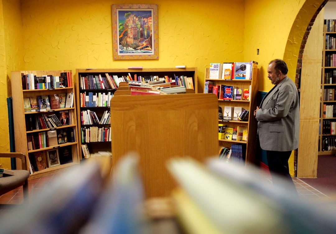 (Trent Nelson | Tribune file photo) Raul Gonzalez, a regular customer, browses the shelves at the Rincon de Libros, a section of Spanish books in Salt Lake City's Sam Weller's Zion Bookstore, May 18, 2004.