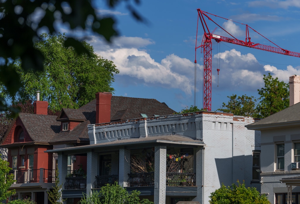 (Leah Hogsten | The Salt Lake Tribune) Older apartment buildings are shadowed by cranes on the downtown city skyline, Tuesday, July 12, 2022. 
