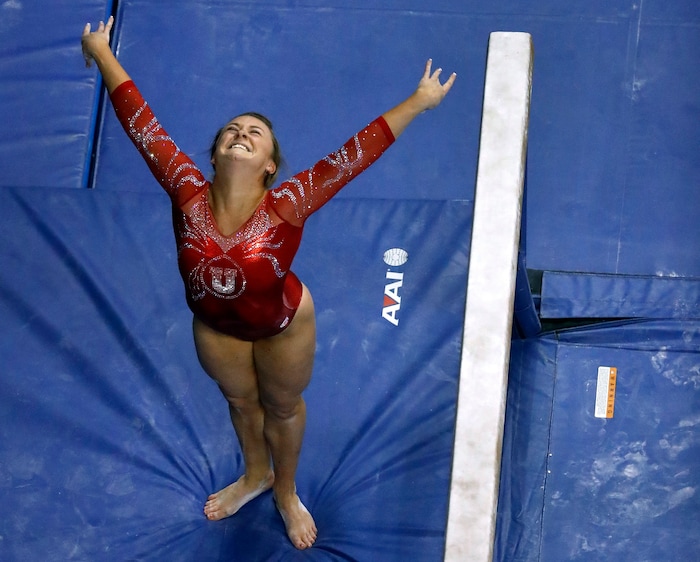 Utah's Maddy Stover smiles after completing her routine on the balance beam during the NCAA college women's gymnastics championships Friday, April 14, 2017, in St. Louis. (AP Photo/Jeff Roberson)