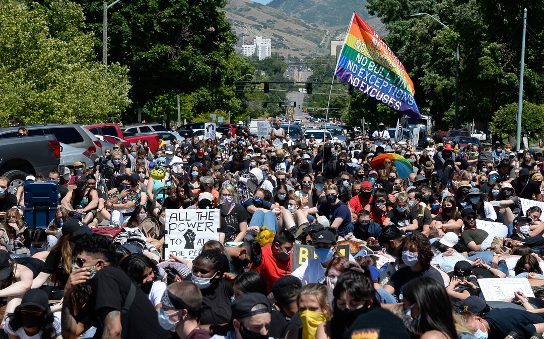 (Francisco Kjolseth  |  The Salt Lake Tribune) Demonstrators stop to protest outside the Salt Lake City Public Safety Building as part of a series of Juneteenth celebrations on Friday, June 19, 2020.