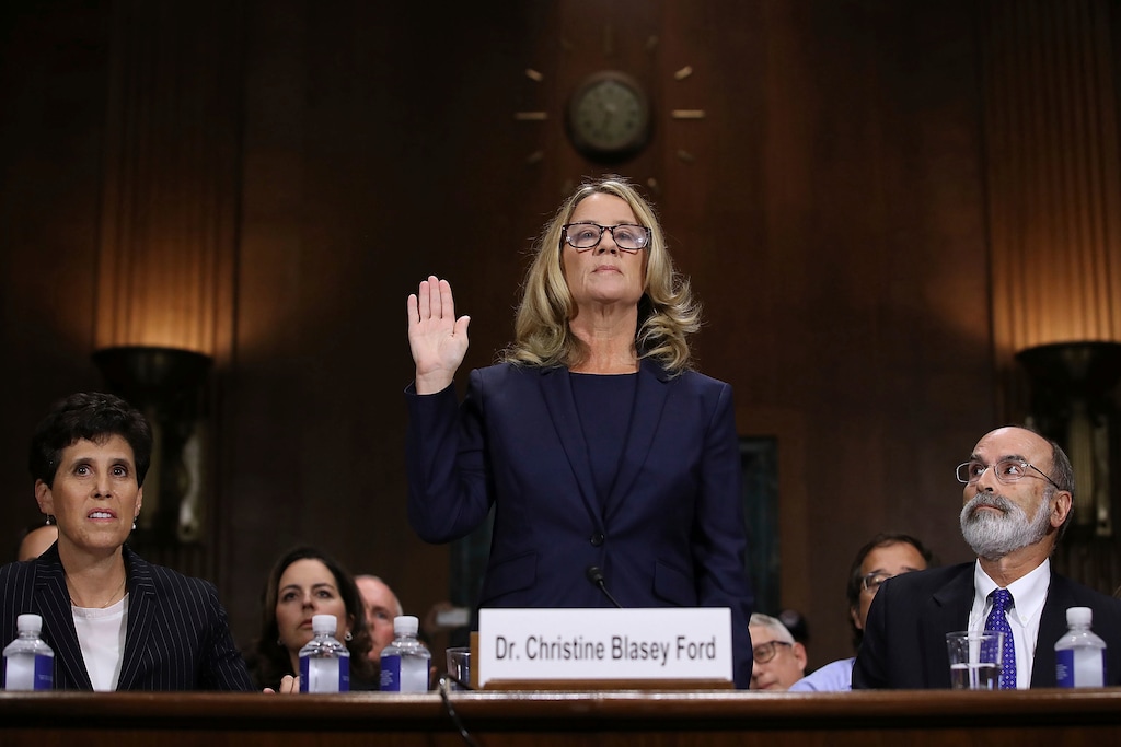 (Win McNamee | AP) Christine Blasey Ford is sworn in before the Senate Judiciary Committee, Thursday, Sept. 27, 2018 in Washington. Her attorney's Debra Katz and Michael Bromwich watch.