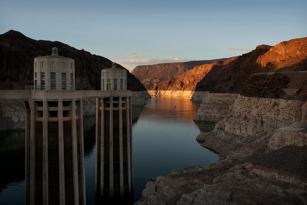 (John Locher | AP file photo) A bathtub ring of light minerals shows the high water line of Lake Mead near water intakes on the Arizona side of Hoover Dam at the Lake Mead National Recreation Area Sunday, June 26, 2022, near Boulder City, Nevada. The Biden administration on Tuesday released an environmental analysis of competing plans for how Western states and tribes reliant on the dwindling Colorado River should cut their use. Department of Interior officials planned to discuss the proposals at Hoover Dam on Tuesday, April 11, 2023.