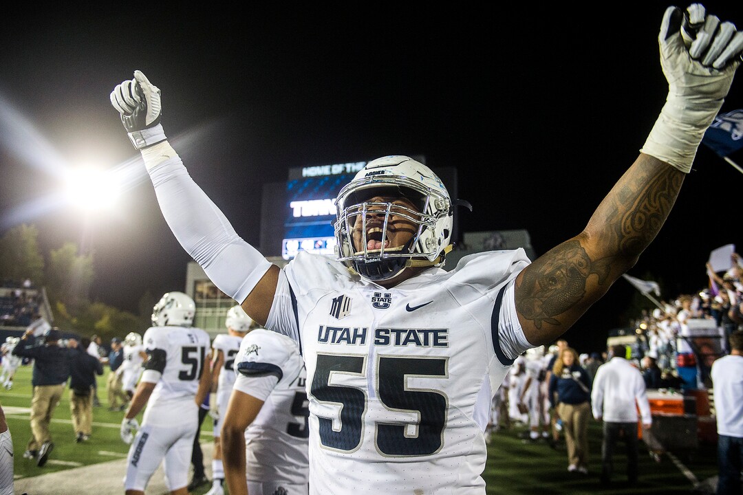 (Chris Detrick  |  The Salt Lake Tribune)  Utah State Aggies defensive end Adewale Adeoye (55) celebrates after the game at Merlin Olsen Field at Maverik Stadium Friday, September 29, 2017. Utah State Aggies defeated Brigham Young Cougars 40-24.