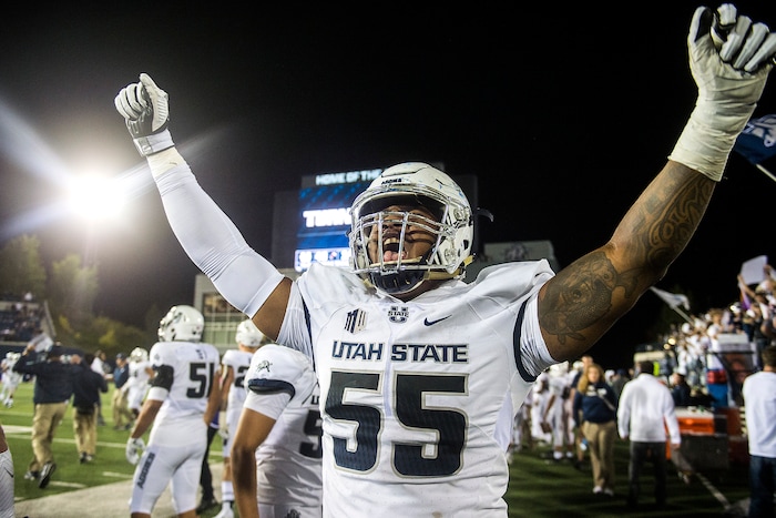 (Chris Detrick  |  The Salt Lake Tribune)  Utah State Aggies defensive end Adewale Adeoye (55) celebrates after the game at Merlin Olsen Field at Maverik Stadium Friday, September 29, 2017. Utah State Aggies defeated Brigham Young Cougars 40-24.