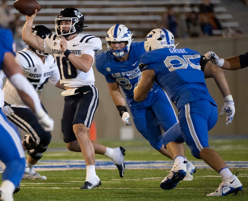 (Christian Murdock | The Gazette via AP) Air Force defensive lineman Caden Blum (87) and defensive end Daniel Grobe (95) pressure Utah State quarterback McCae Hillstead (10) during the second half of an NCAA college football game in Air Force Academy, Colo., Friday, Sept. 15, 2023.
