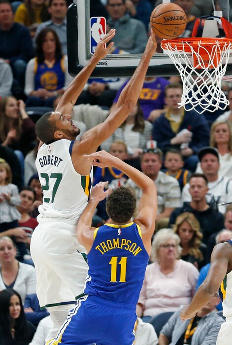 Utah Jazz center Rudy Gobert (27) goes to the basket as Golden State Warriors guard Klay Thompson (11) defends in the first half during an NBA basketball game Friday, Oct. 19, 2018, in Salt Lake City. (AP Photo/Rick Bowmer)