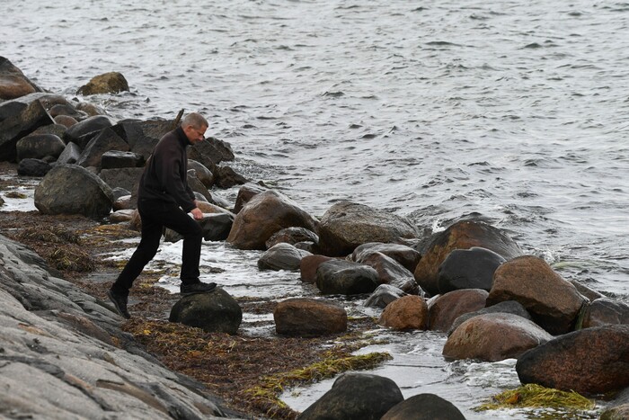 A police officer attends the south coast of the isle of Amager, near Copenhagen, Denmark, Monday Aug. 21, 2017. The body of a woman has been found in the Baltic Sea near where a missing Swedish journalist is believed to have died on a privately built submarine, police in Denmark said late Monday. (Kenneth Meyer/Ritzau Foto via AP)