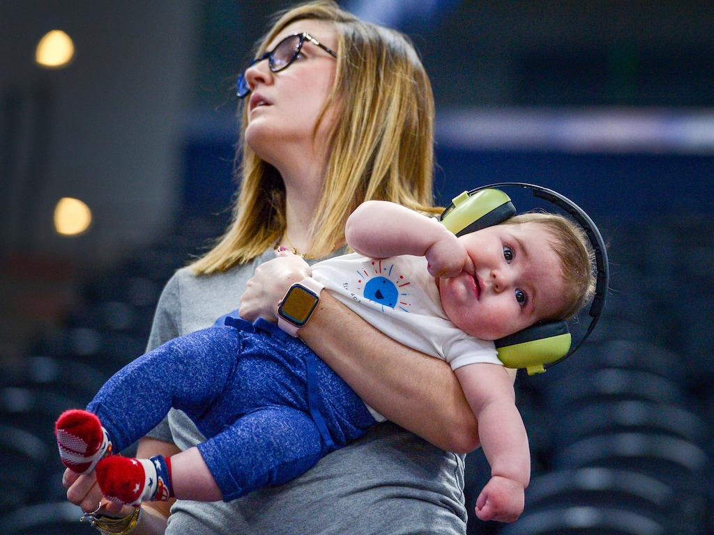 Leah Hogsten | The Salt Lake Tribune Ali Segebrecht holds her 6-month-old son Hughes during Kansas Jayhawks practice at the 2019 NCAA Division I Men's Basketball Championship, March 20, 2019 in preparation for their first round game against the Northeastern Huskies on Thursday. Segebrecht is a Kansas alumni and moved from Lawrence to Salt Lake City a year ago.