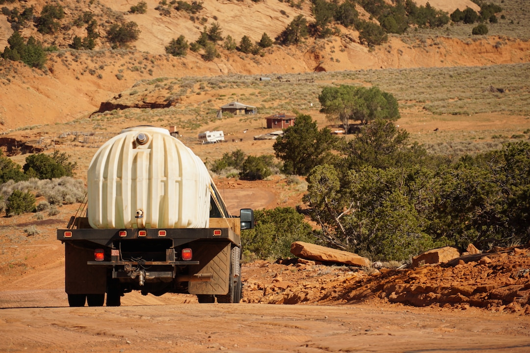 (Zak Podmore | The Salt Lake Tribune) Donovan Smallcanyon drives 1,200 gallons of water down a steep section of road to Piute Mesa in Utah on his water delivery route with the nonprofit DigDeep on July 1, 2020.